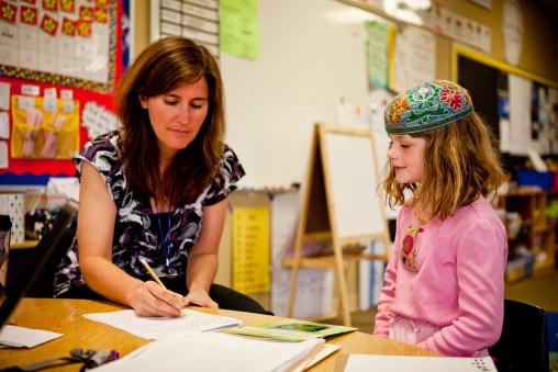 Teacher writing with student